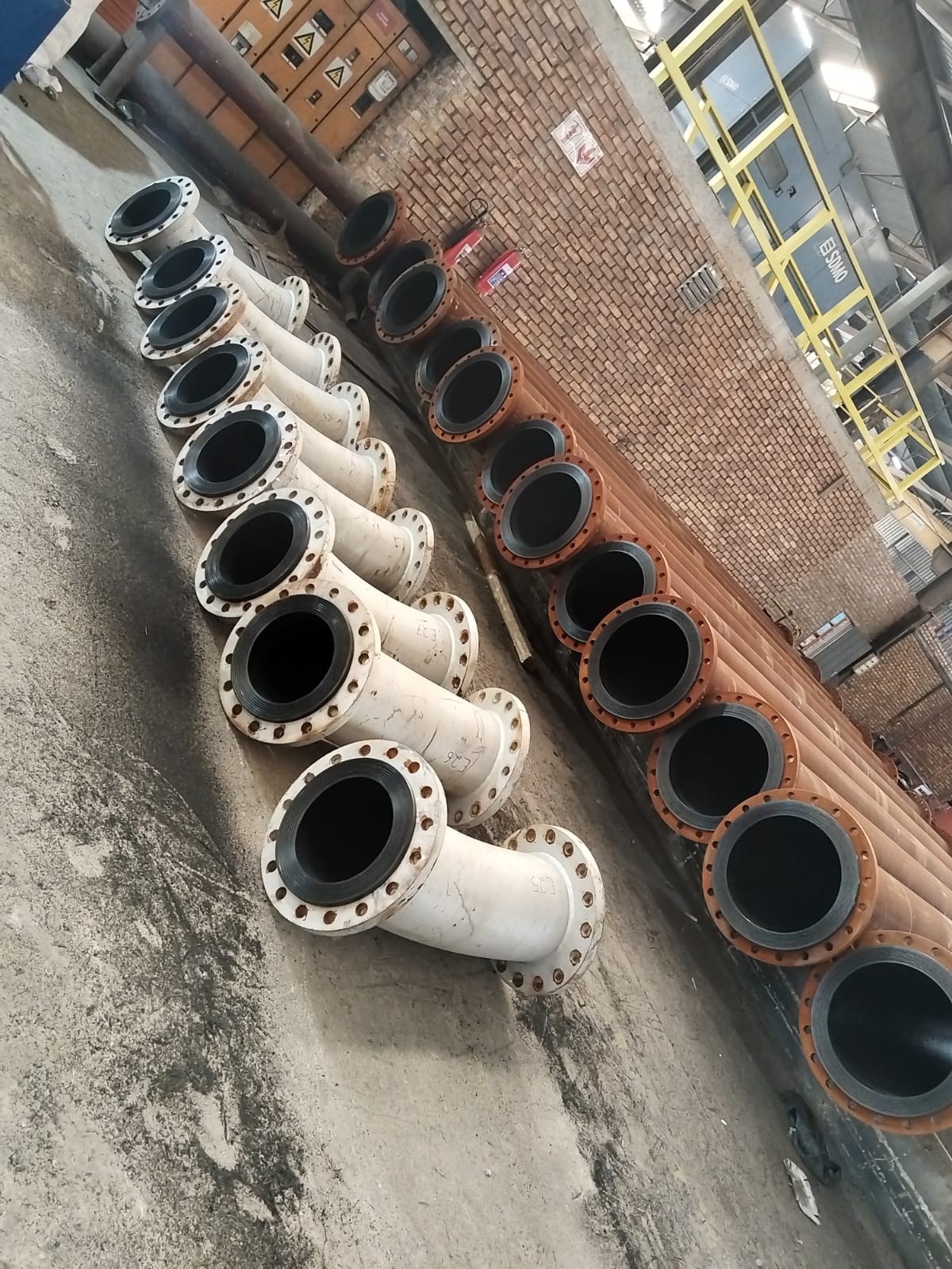 Lined flanged steel pipe spools staged in the Wetpipe workshop