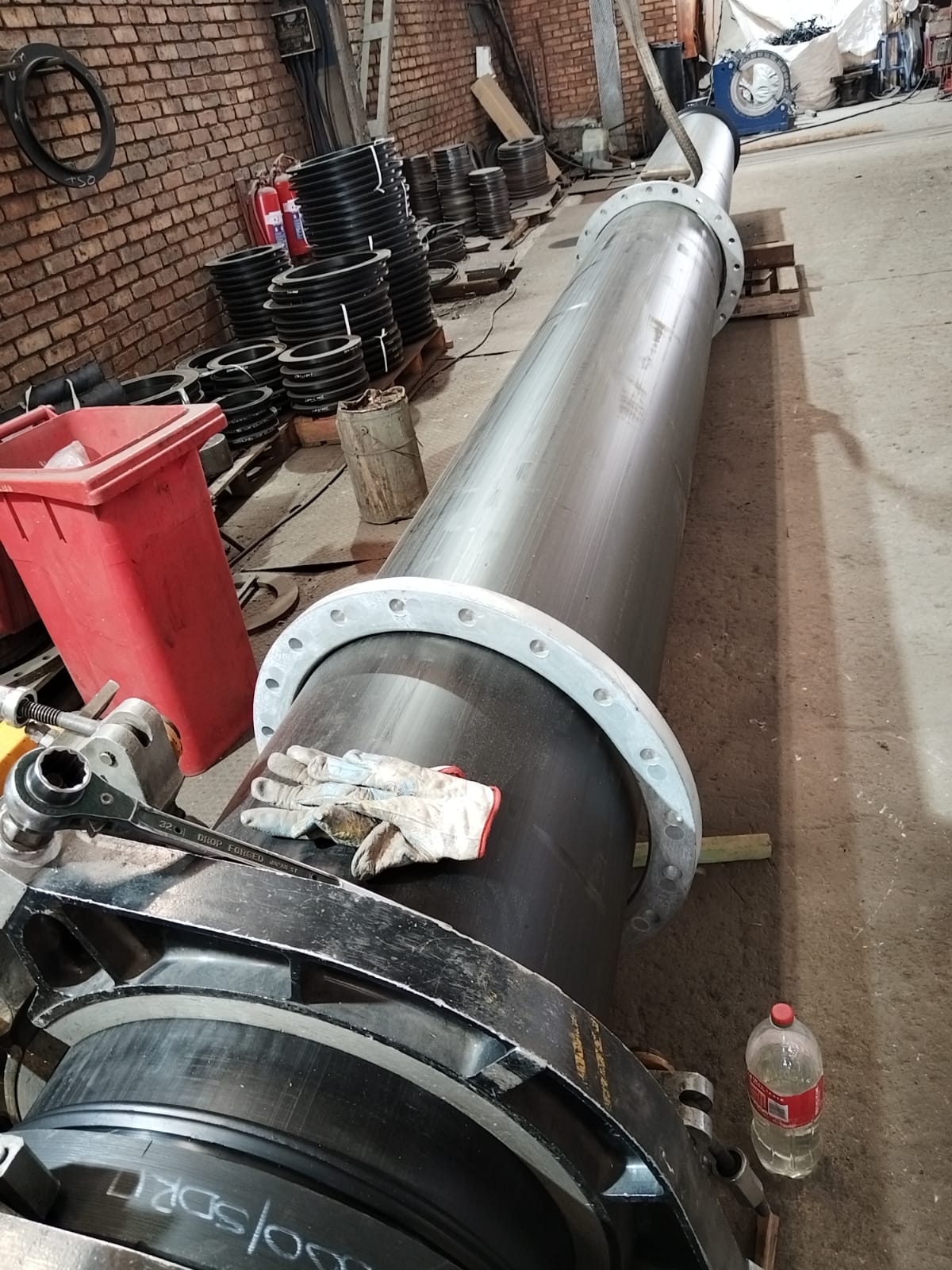HDPE liner being inserted into a steel carrier pipe with stub-end flanges at Wetpipe